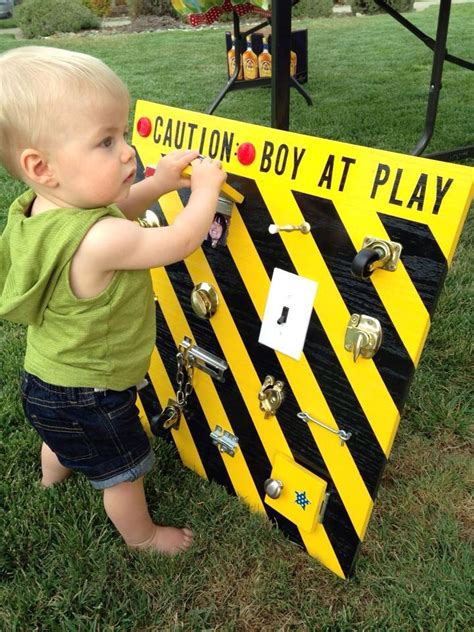 Baby sensory toys are another perfect gift for their first birthday. Boy at play board. 1 year old birthday gift. Genius Idea ...
