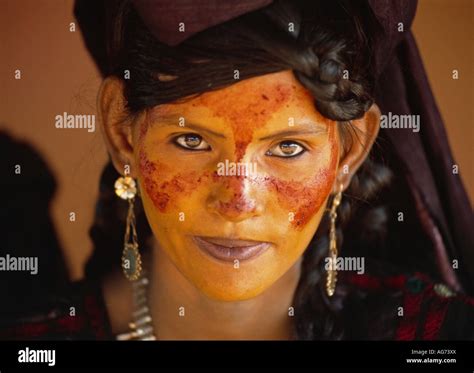 Niger Near Agadez Painted Face Of Young Woman Of Tuareg Tribe And