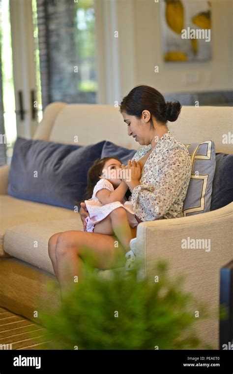 Hispanic Woman Breastfeeding Her Two Year Old Daughter Stock Photo Alamy