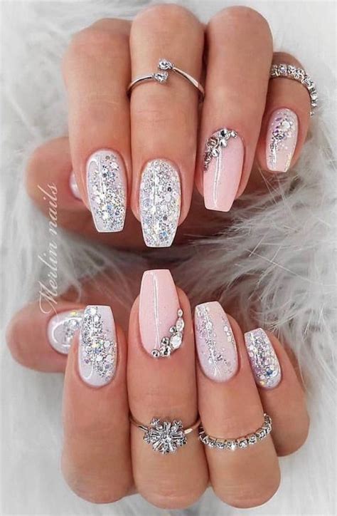 Some Pretty Pink And White Nail Designs On Someones Hands With Diamond