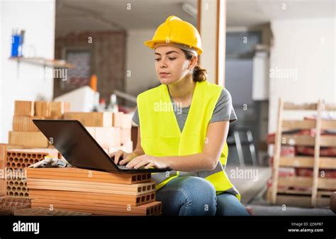 Female Civil Engineer Using Laptop At Construction Site Indoors Stock