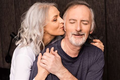 Mature Woman Kissing Cheek Of Happy Husband With Closed Eyes Stock Image Colourbox