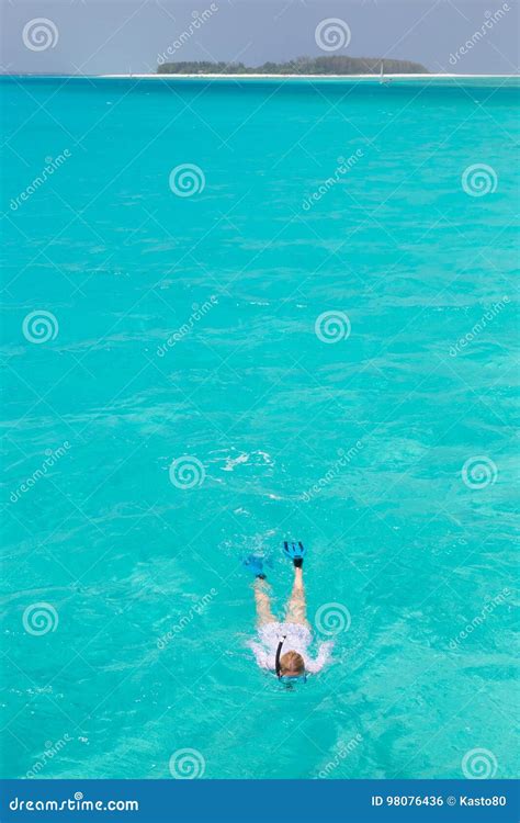 Woman Snorkeling In Clear Shallow Sea Of Tropical Lagoon With Turquoise