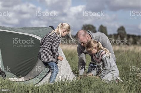 Handsome Redhead Father And Blonde Daughters Enjoying A Camping Holiday