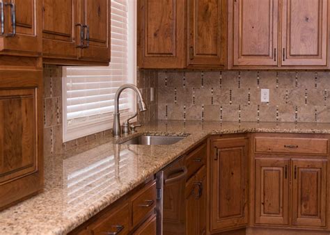 New venetian gold granite countertops possess warm, gold, neutral tones, and black, gray and brown veining. kitchen counter tops - venetian gold cabinets - dark maple ...