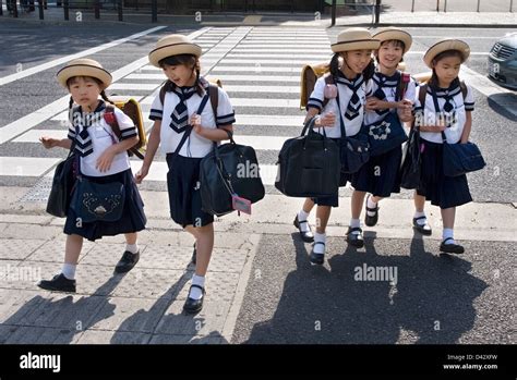 Five Elementary School Girls In Sailor Uniforms And Cute Hats Crossing