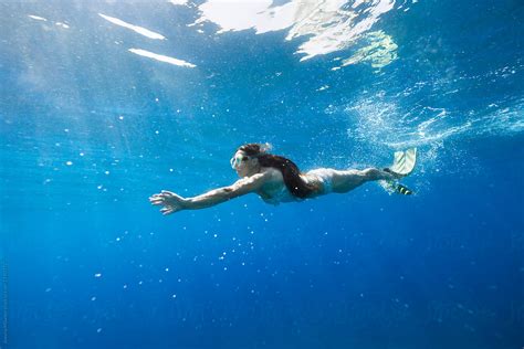 Young Woman With The Long Hair Swimming Trough The Sea Underwater