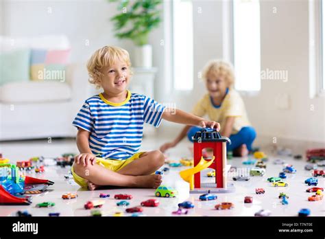 Kids Play With Toy Cars In White Room Little Boy Playing With Car And