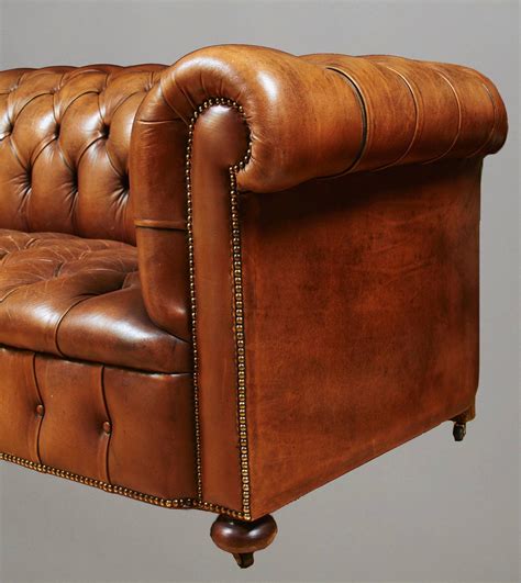 Brown Leather Couch With Nailhead Trim The Couch Is Upholstered With