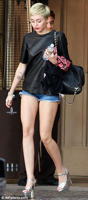 Shimmering Rock Takes Center Stage As Miley Cyrus Shows Off Her Long Limbs In Denim Shorts