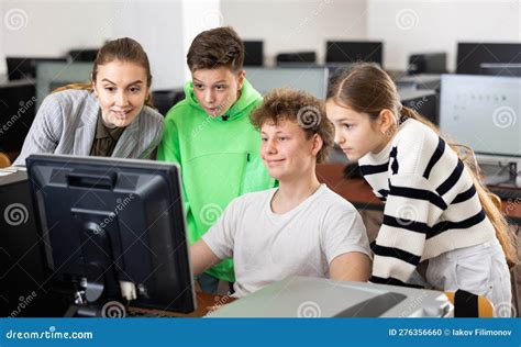 Teacher And Classmates Using Computer During Lesson Stock Photo Image