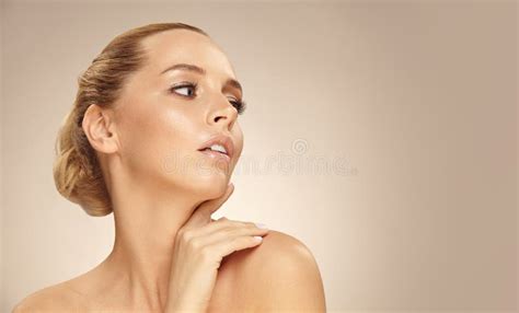 Beautiful Young Woman With Clean Fresh Skin Touch Own Face Looking Away