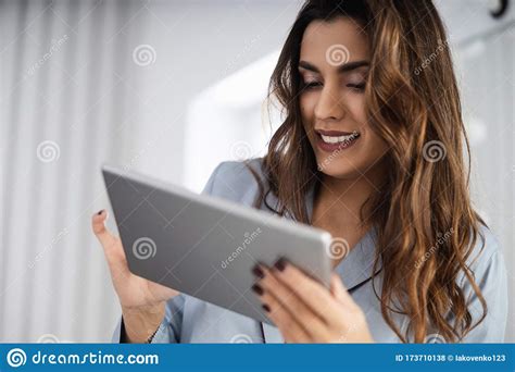 Happy Cute Lady Is Holding Gadget In Bedroom Stock Photo Image Of