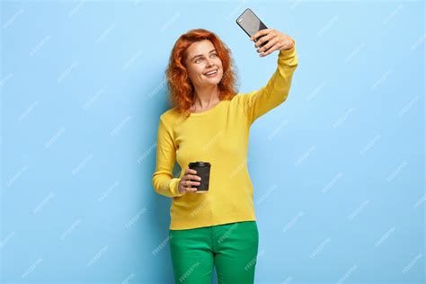 Free Photo Smiling Good Looking Ginger Woman Takes Selfie On Modern Cellular To Upload In