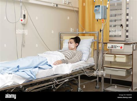 Sick Young Woman Laying In Hospital Bed With Central Venous Catheter