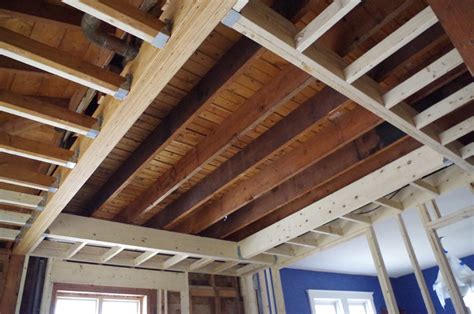 Once the walls are erected, the ceiling joists are placed on the walls to serve as a supporting frame for the next level. Raised Ceiling Joists | Taraba Home Review