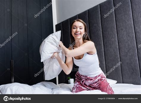 Cheerful Woman Holding Pillow Smiling Bedroom — Stock Photo