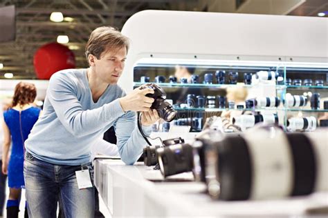 Man Photographer Tests Digital Slr Camera In Shop Stock Image Image