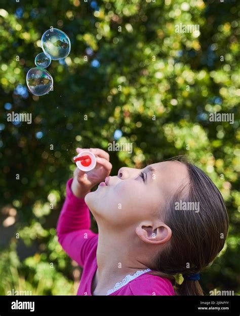 Nothing Says Childhood Like Blowing Bubbles Shot Of A Cute Young Girl