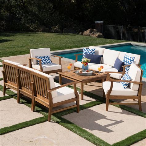 The set comes with a sofa, two chairs, a loveseat, and a table. Noble House Giancarlo Teak 9-Piece Wood Outdoor Sofa Set with Cream Cushions-303726 - The Home Depot