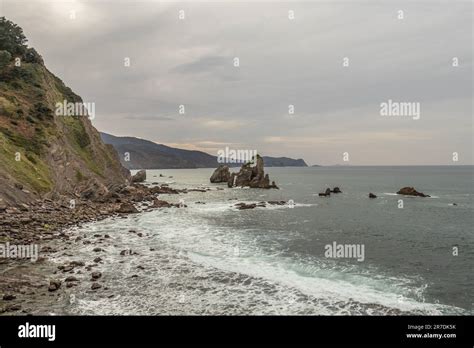 Cliffs And Rocks In Ocean At San Juan De Gaztelugatxe A Basque Coastal