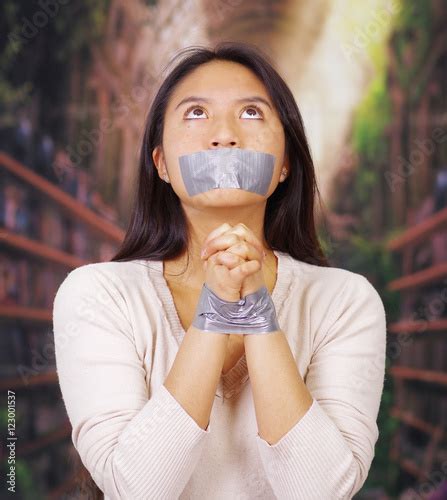 Young Brunette Woman Wearing White Sweater Gagged And Tied With Duct