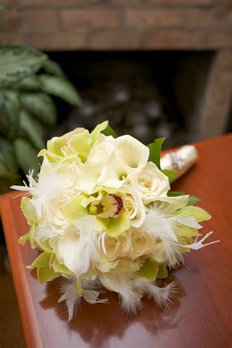 A Bridal Bouquet Sitting On Top Of A Wooden Table