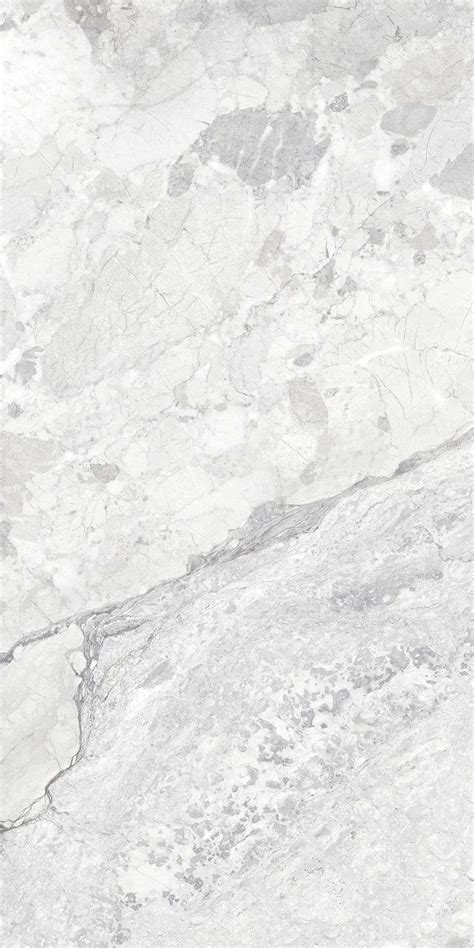 A White Marble Textured Surface With Grey Veiners And Cracks In The Top