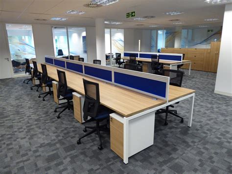 New Open Plan Office Space With Blue Desk Dividers Separating The