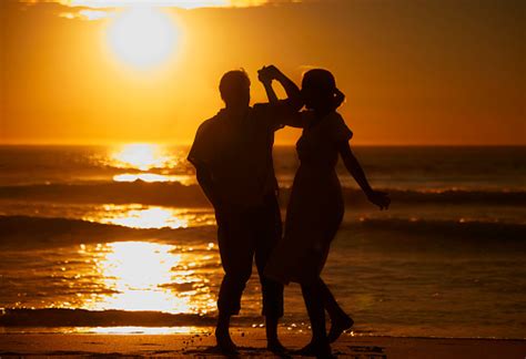 Silhouette Affectionate Senior Couple Sharing An Intimate Moment On The
