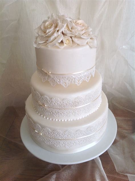 Beautiful lace effects can be created on cake in lots of different ways including lace piping, lace applique, stencilled lace and with edible lace/lace mats. Wedding Cake with Edible Lace and Sugar Roses. www ...