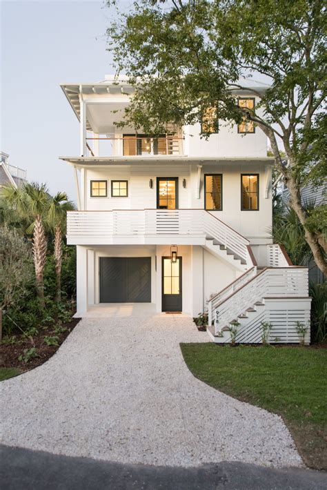 Beautiful 3 Storied White Home Exterior With Black Doors And Windows