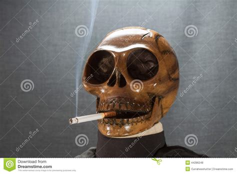 Human Skull Smoking A Cigarette On A Black Background