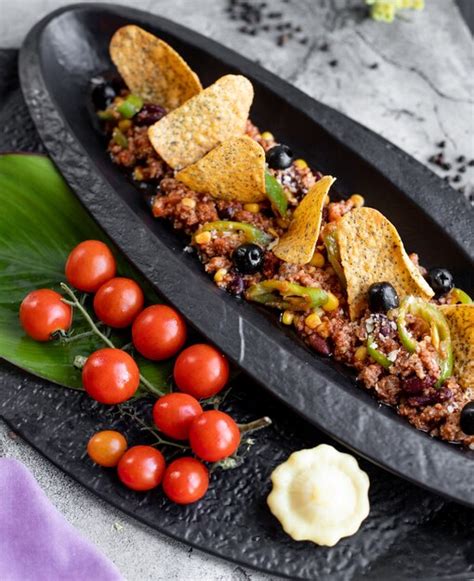 Free Photo Minced Meat Served With Corn Pepper Olive And Tortilla