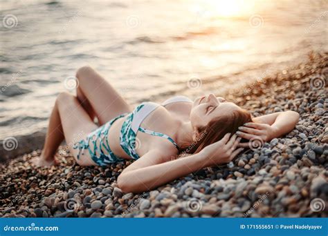 fashion shot of a beautiful girl in bikini lying on beach stock image image of lies resort
