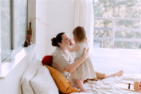 Mother And Daughter Having Fun In Bedroom While Spending Time Together