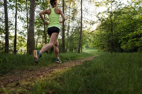 Athletic Woman Running On A Forest Stock Photo Pixeltote
