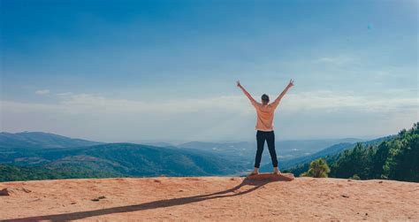 Person In Beige Top On Mountain Cliff · Free Stock Photo
