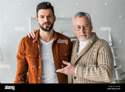 Senior Father Gesturing Near Handsome Bearded Son Stock Photo Alamy