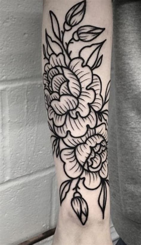 A Black And White Flower Tattoo On The Arm