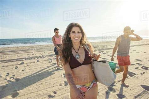 Group Of Friends Walking On Beach Stock Photo Dissolve