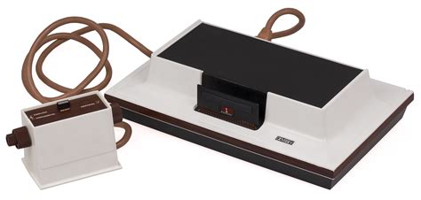 A White And Brown Electronic Device Sitting On Top Of A Table Next To A