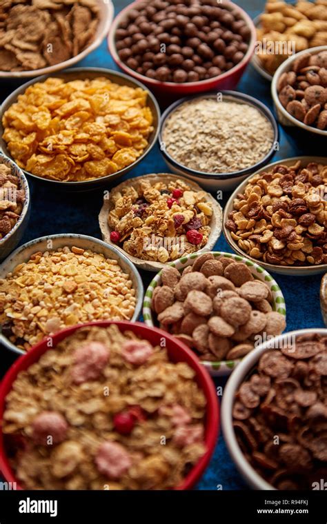 Assortment Of Different Kinds Cereals Placed In Ceramic Bowls On Table