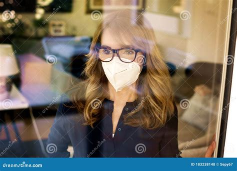 Close Up Portrait Of Mature Woman Wearing Face Mask At Home For