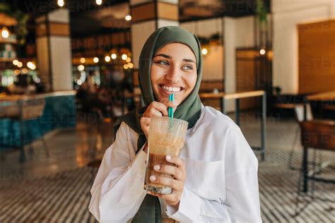 Beautiful Woman With A Hijab Smiling Happily While Drinking A Milkshake In A Cafe Cheerful