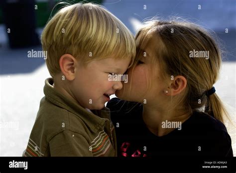 Sister Kissing Baby Brother Stock Photo Alamy