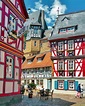 colorful buildings line the street in an old european town with ...