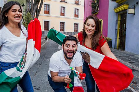 Mexican People With Flags To Celebrate Mexican Independence Day In