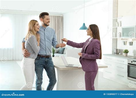 Female Real Estate Agent Giving House Key To Couple Stock Image Image Of Mature Background