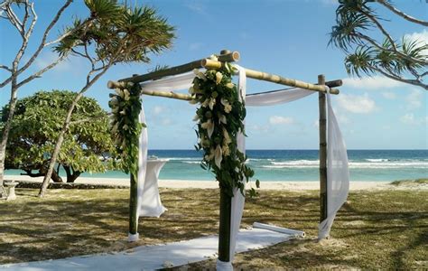 Bamboo Wedding Arbour With White Muslin Floral Arrangement And White